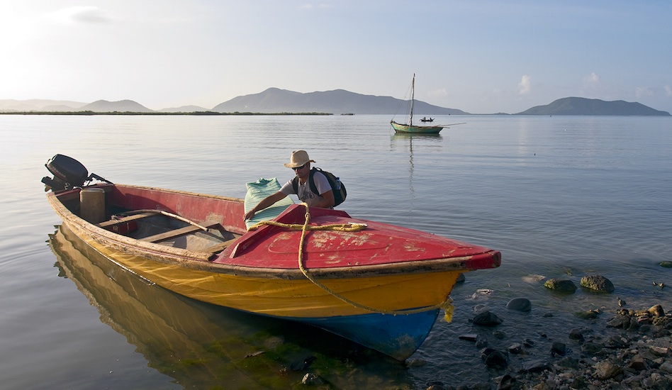 Early morning calm in Aquin as Emiliano Cataldi loads boards for a boat trip to distant Caribbean reefs.  Photo: John Seaton Callahan.
